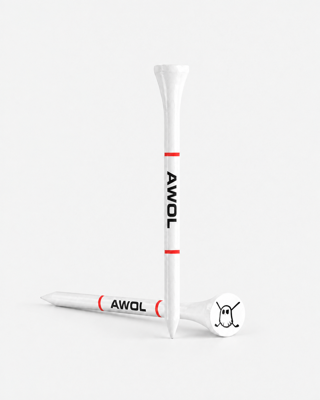 Two white tees with red bands and black 'AWOL' text, shown on a clean light gray studio background. One tee is upright and one lies on its side, with a white club head resting on the tee base.