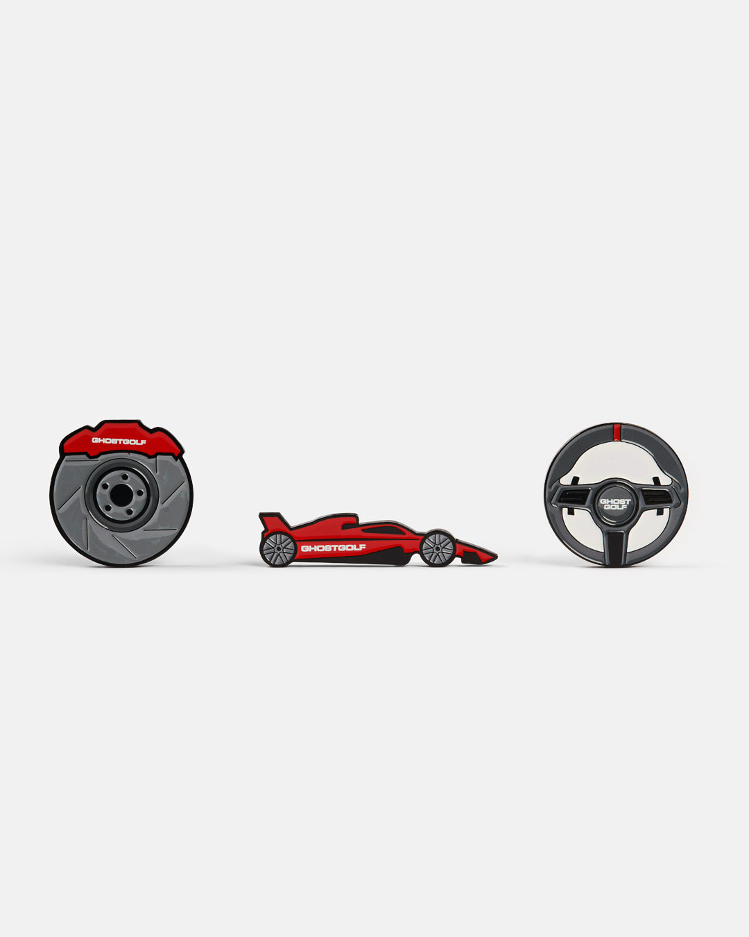 Product photo featuring three ball markers: one with a brake disc design displaying “Ghost Golf” at the top, one featuring a red racing car with “Ghost Golf” on the side, and one with a racing wheel design.