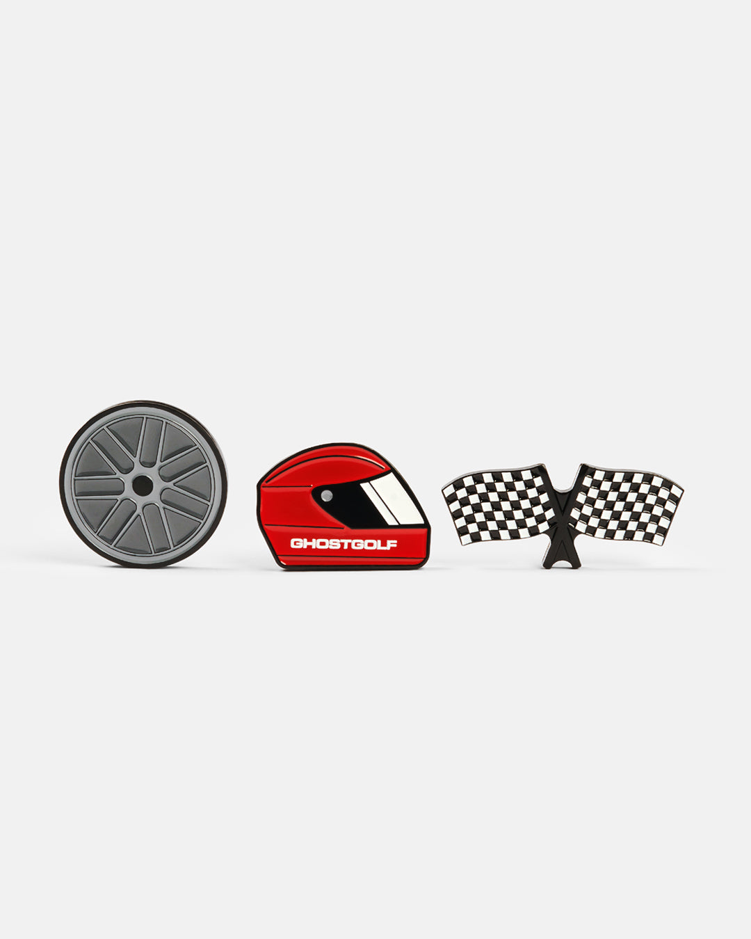 Product photo featuring three ball markers: one with a racing helmet design displaying “Ghost Golf” on the side, one with a racing wheel design, and another shaped like checkered racing flags.