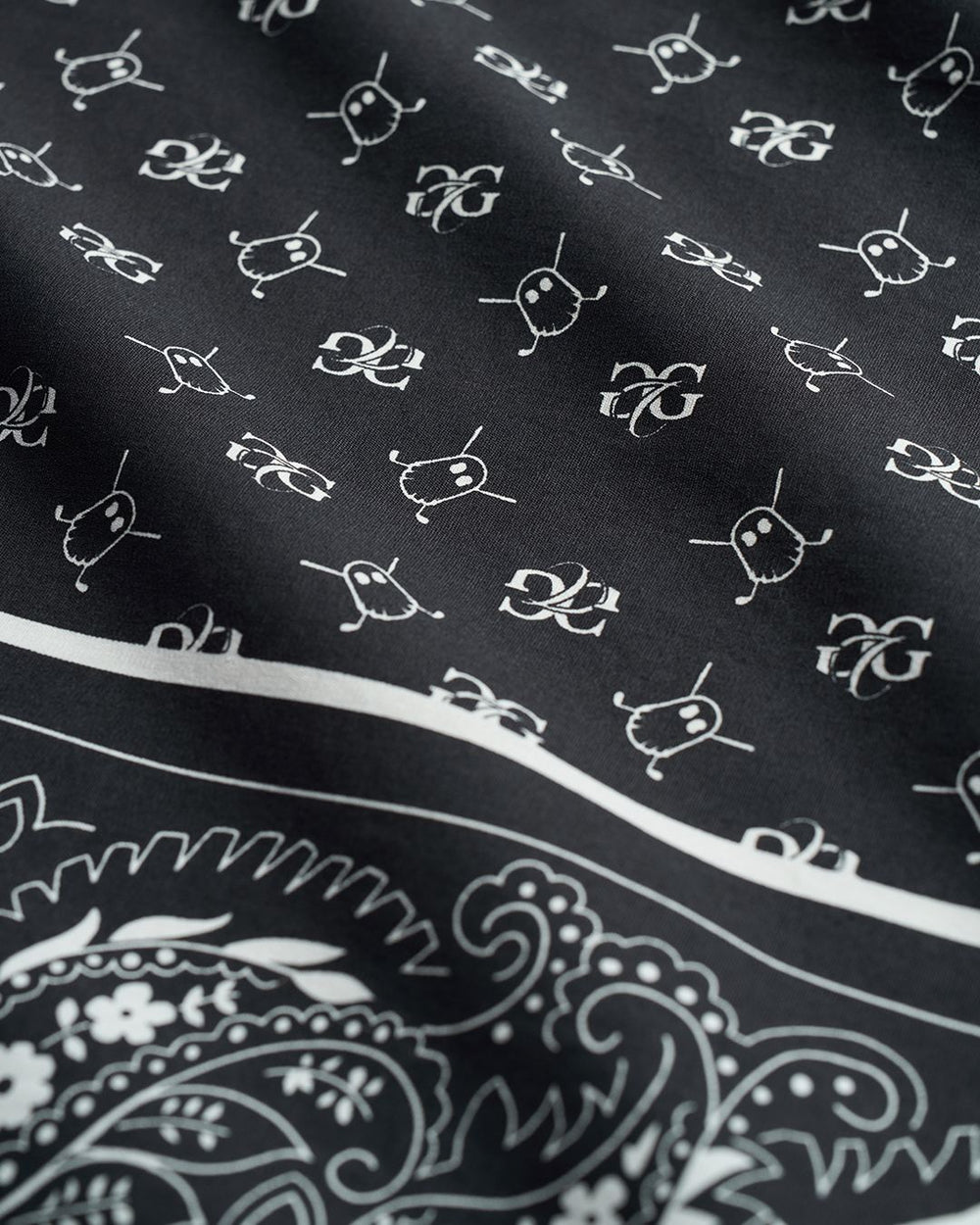 Closeup detail shot of Black Rebels Bandana showcasing GGC and ghost icon as pattern on bandana #color_black