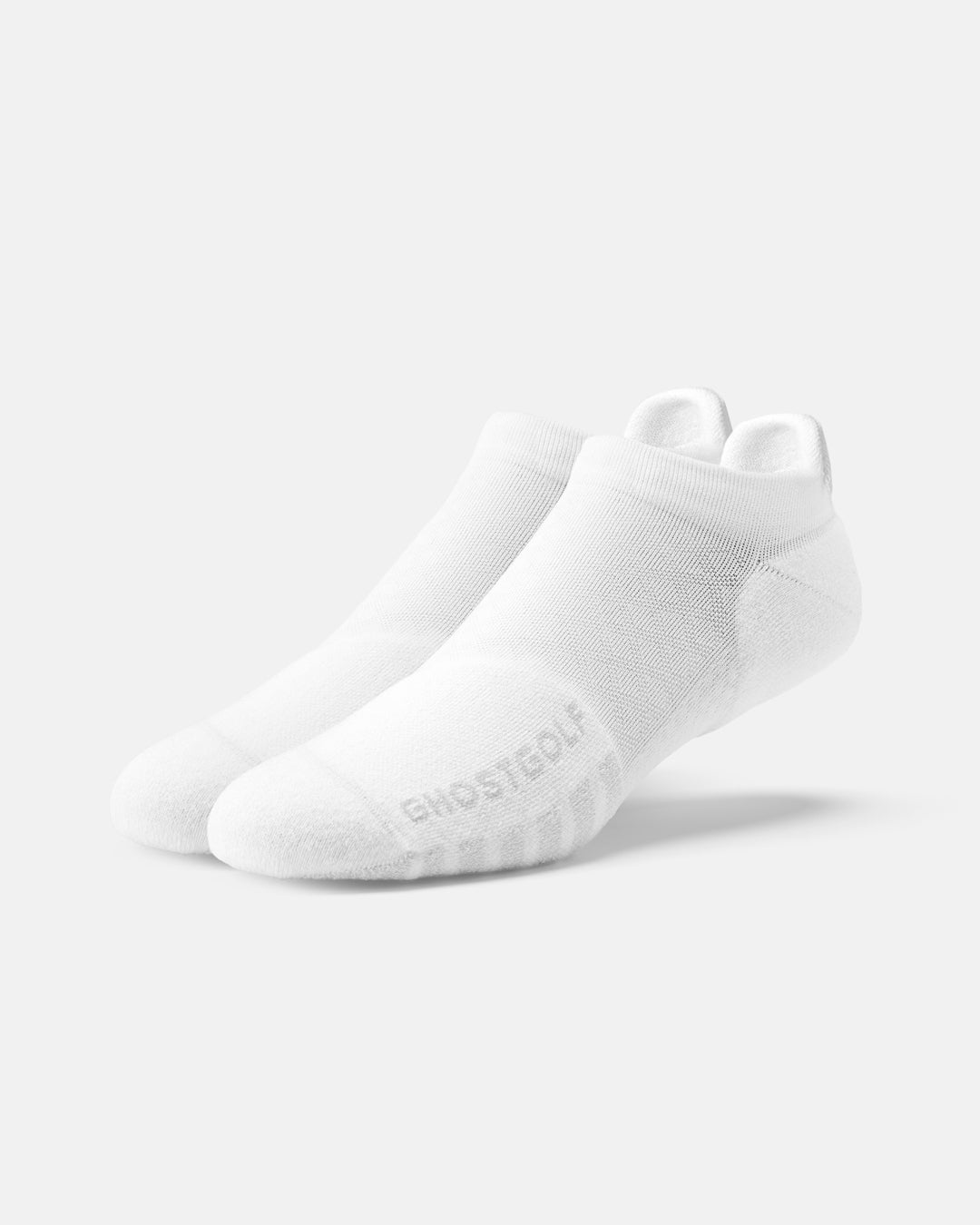 Front product shot of white ankle socks, with one sock featuring ghost golf #color_white